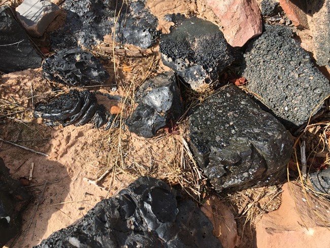 These black shiny rocks are slag from the smelter