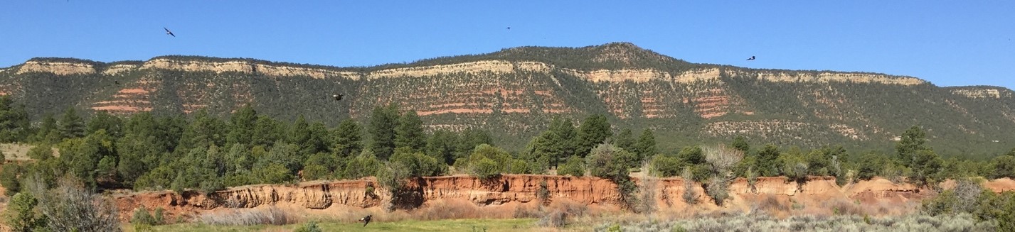green and orange stone hill and blue sky