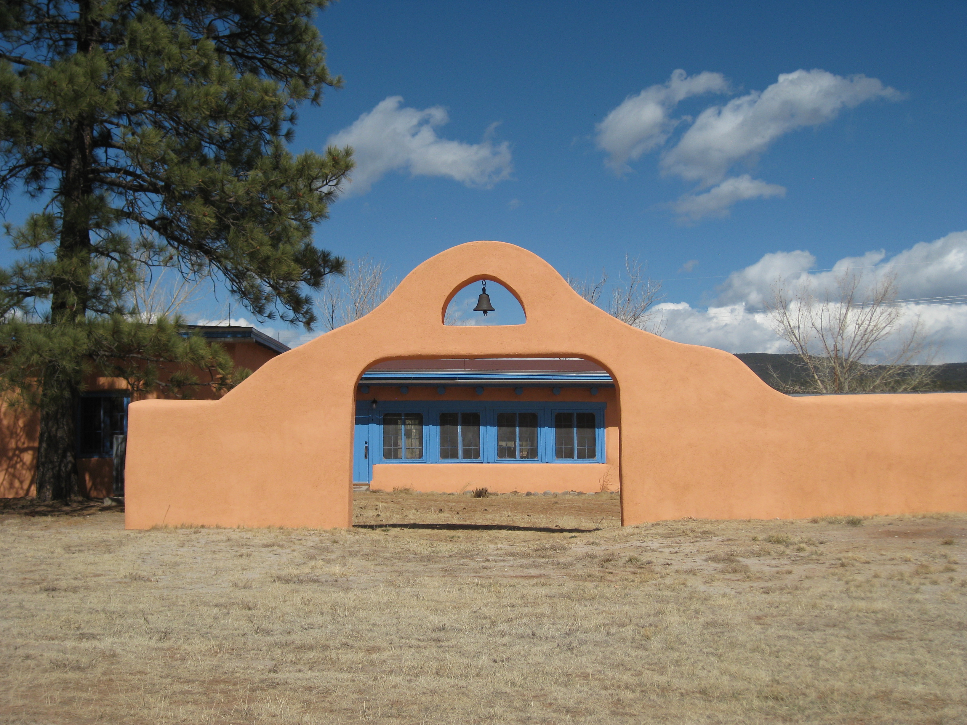 Blue Sky, Adobe Building, Arched Gate with Bell
