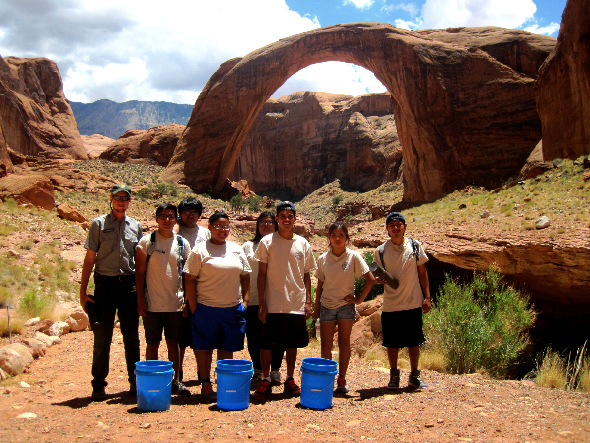 2014 NCC crew working at Rainbow Bridge, bridge behind them