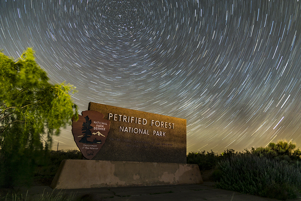 Entrance Sign with Star Trails in a Night Sky