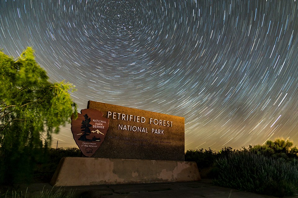 Entrance Sign with Star Trails in a Night Sky