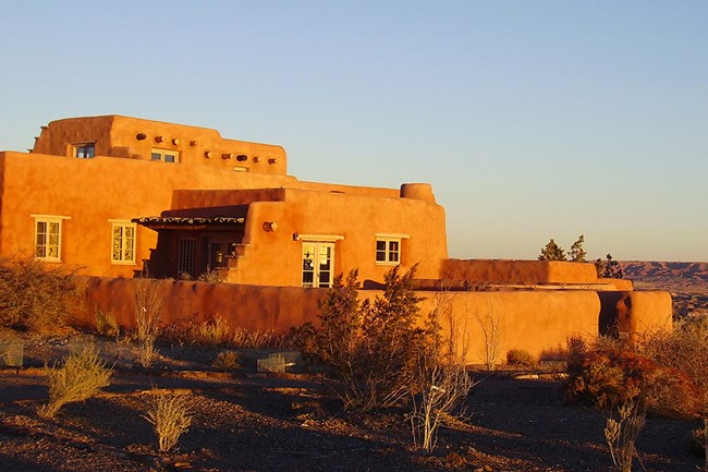 Historic Painted Desert Inn glows in the light of sunrise