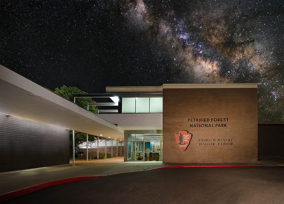 Night at the Painted Desert Community Complex, stars above the softly lit historic buildings.