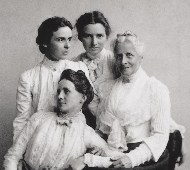 elderly mother with three adult daughters, black and white historic photo