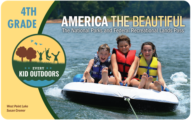 Photo of 4th Grade pass with three kids on a water tube.