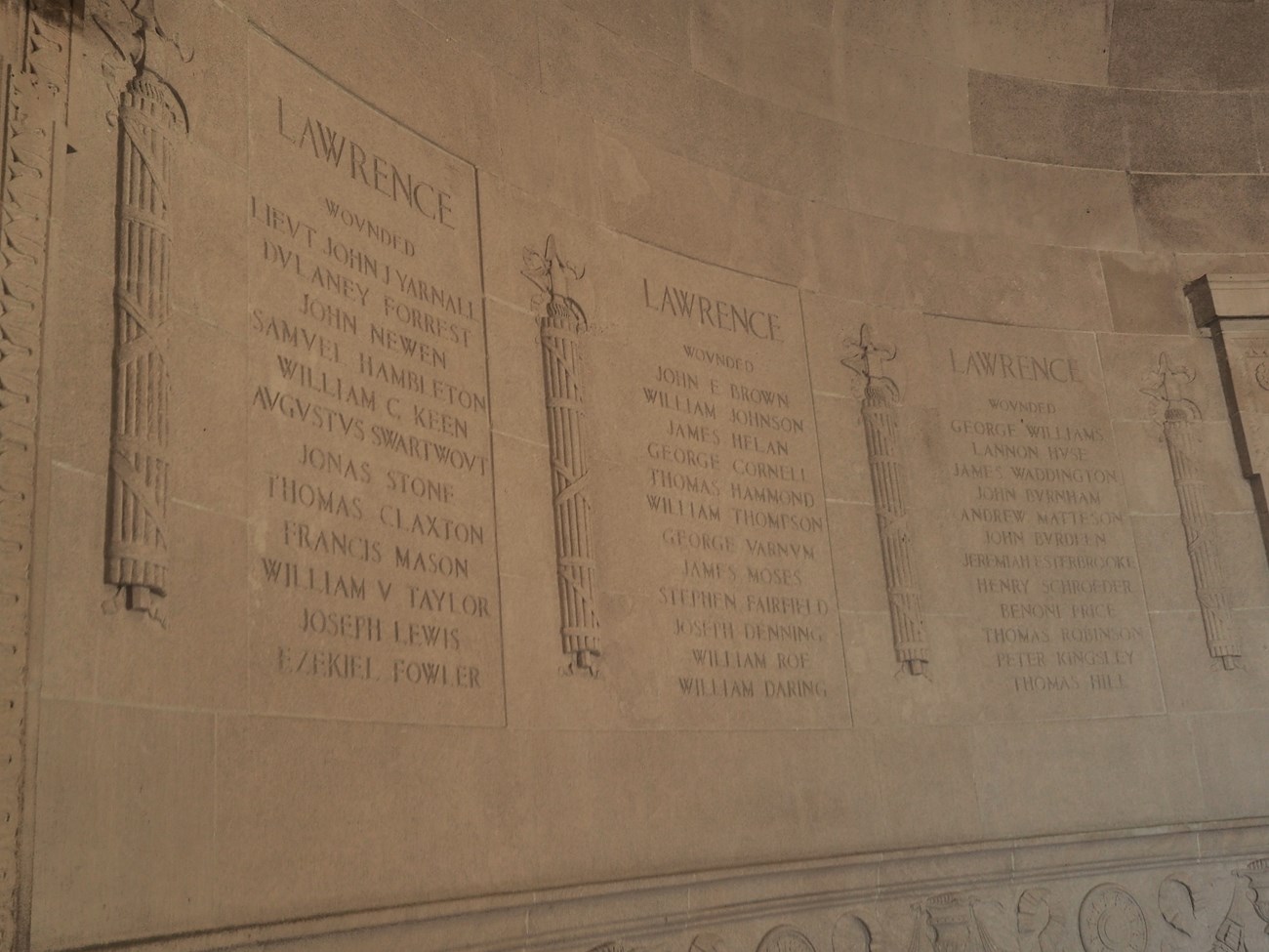 limestone wall with three columns are engraved with the name of a vessel from the Battle of lake Erie and the men who were wounded and killed
