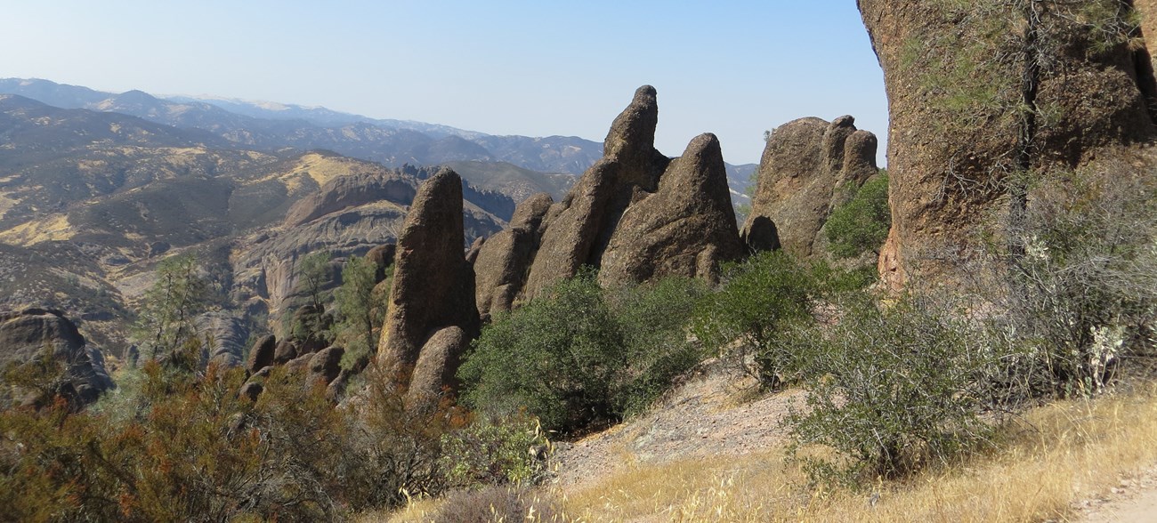 Rock spires stand next to the trail.