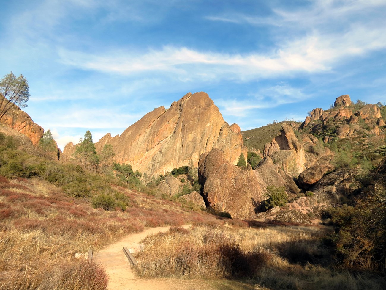 A trail winds through rock formations.