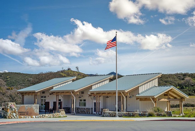 A single story building. American flag and entrance door are visible.