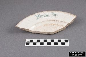 A fragment of a blue and white plate which reads 'Marshall Hall'