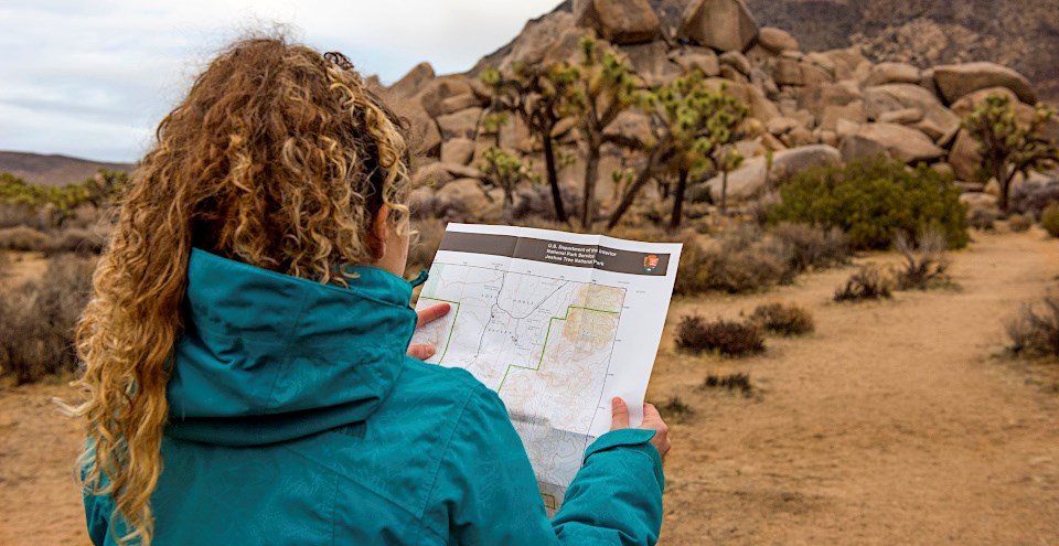 Women studying map in desert landscape