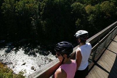 2 bikers look onto the river below