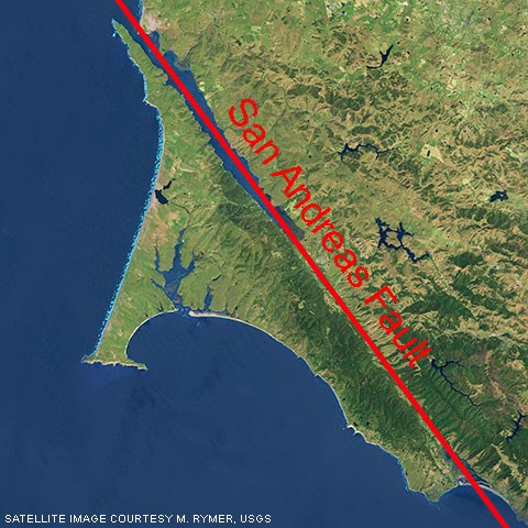 A color satellite photo of Point Reyes with a red line marking the San Andreas Fault.