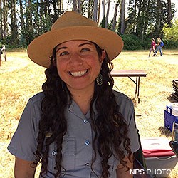 A head photo of Point Reyes Social Media Team member Fiona wearing a gray ranger shirt and a ranger hat.