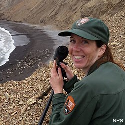 Point Reyes Social Media Team member Sarah watching elephant seals through a spotting scope.