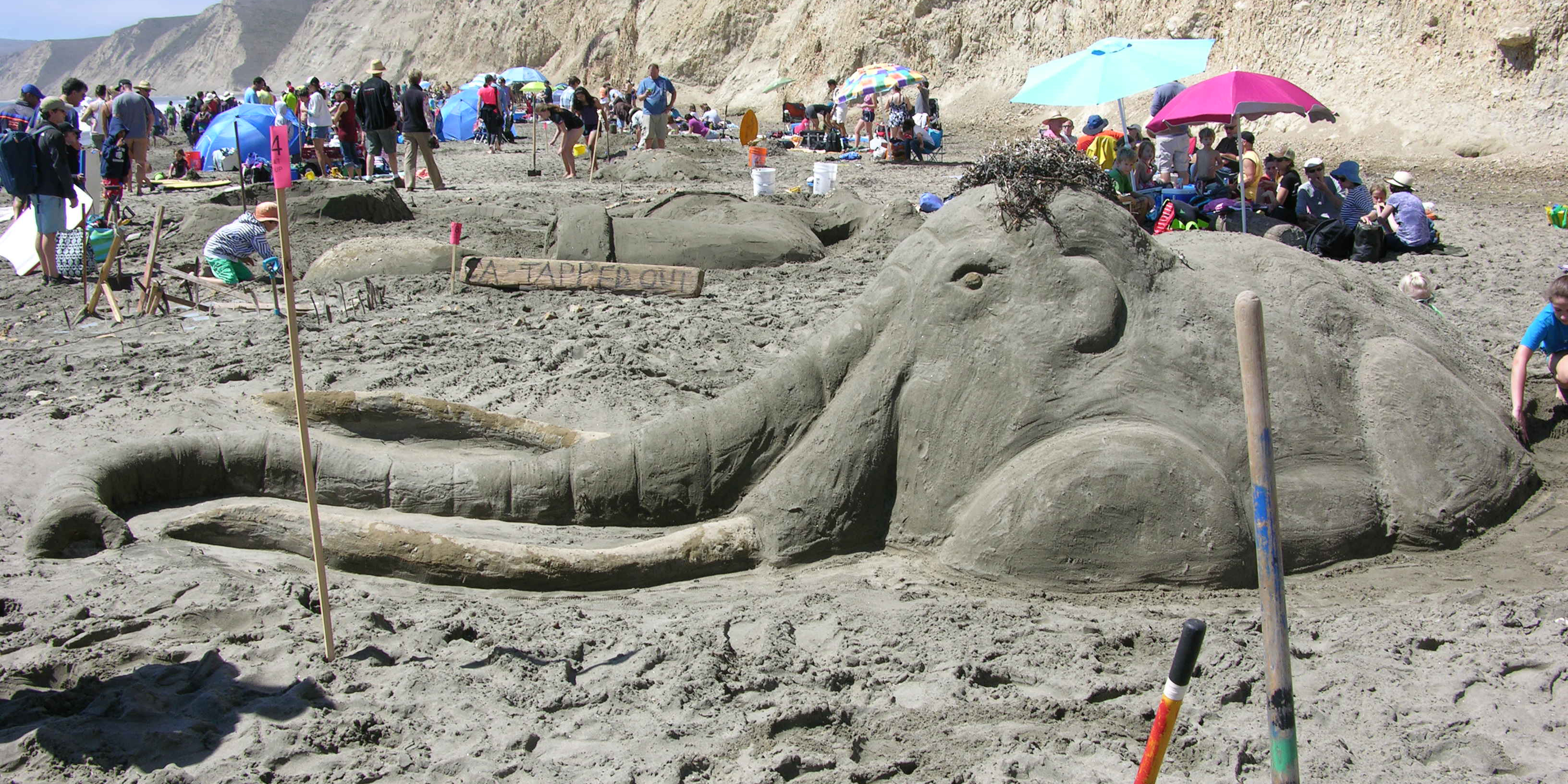 A large sand sculpture of a woolly mammoth.