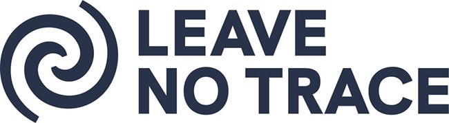 Two dark gray lines form a spiral pattern adjacent to the words Leave No Trace.