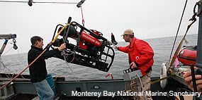 Two individuals launching a robotic submersible. Photo courtesy Monterey Bay National Marine Sanctuary