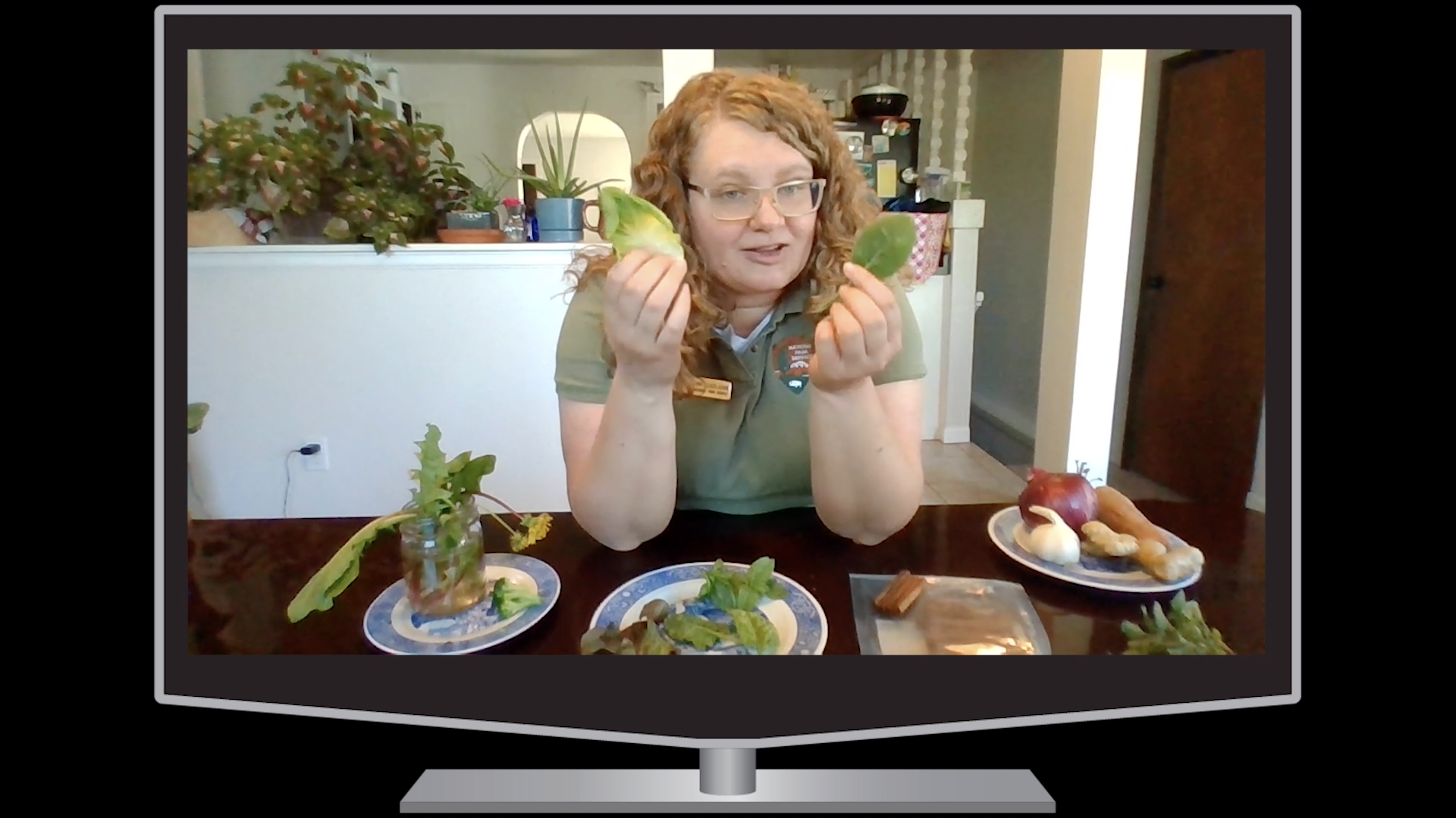 a young woman sitting at a table full of vegetables