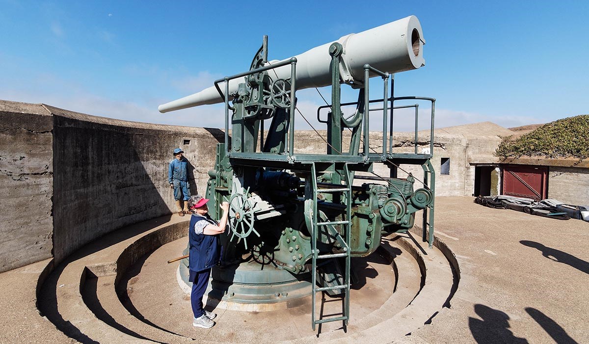 visitors interact with the battery gun