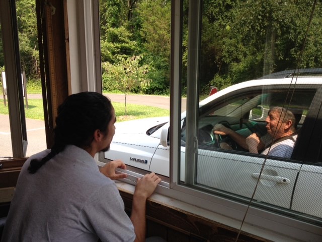 a YCC member talks to a visitor at the entrance station