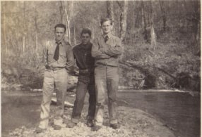 3 CCC members stand by river in the 1930s