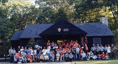 Large group of volunteers sitting on the steps of the visitor center