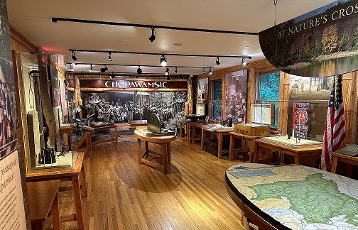 Interior of a wooden building with museum displays and exhibits