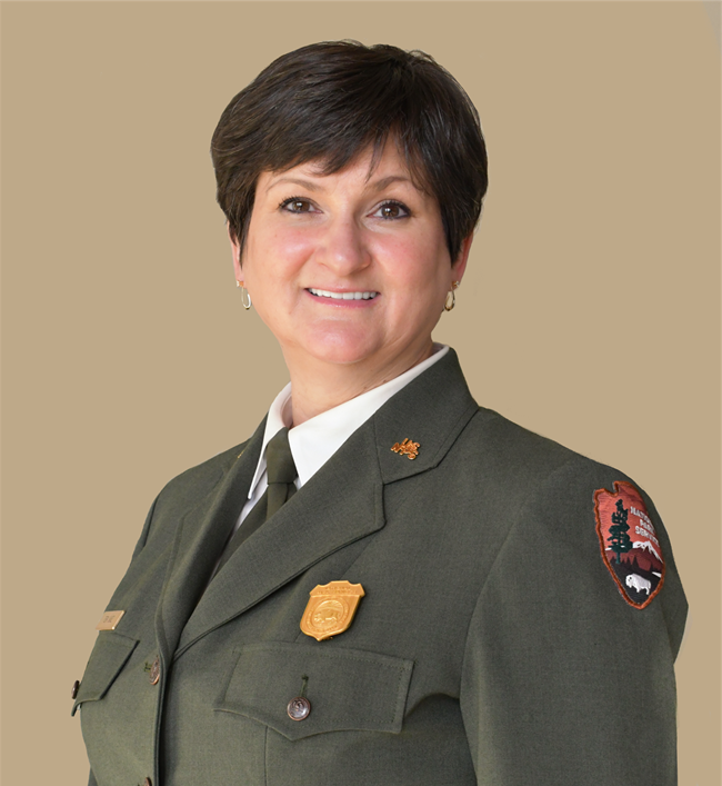 Women smiles wearing nps green formal jacket