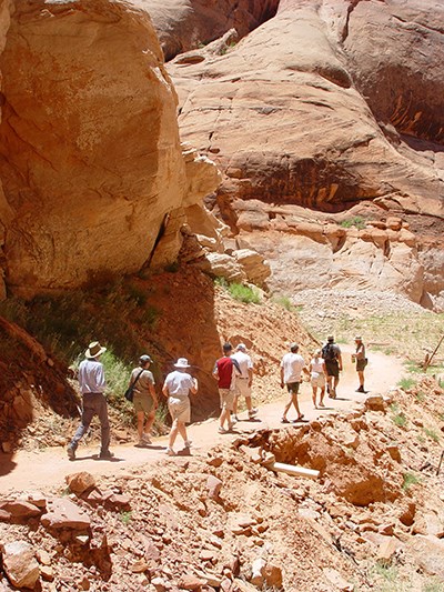Ranger leads group of visitors on trail through canyon