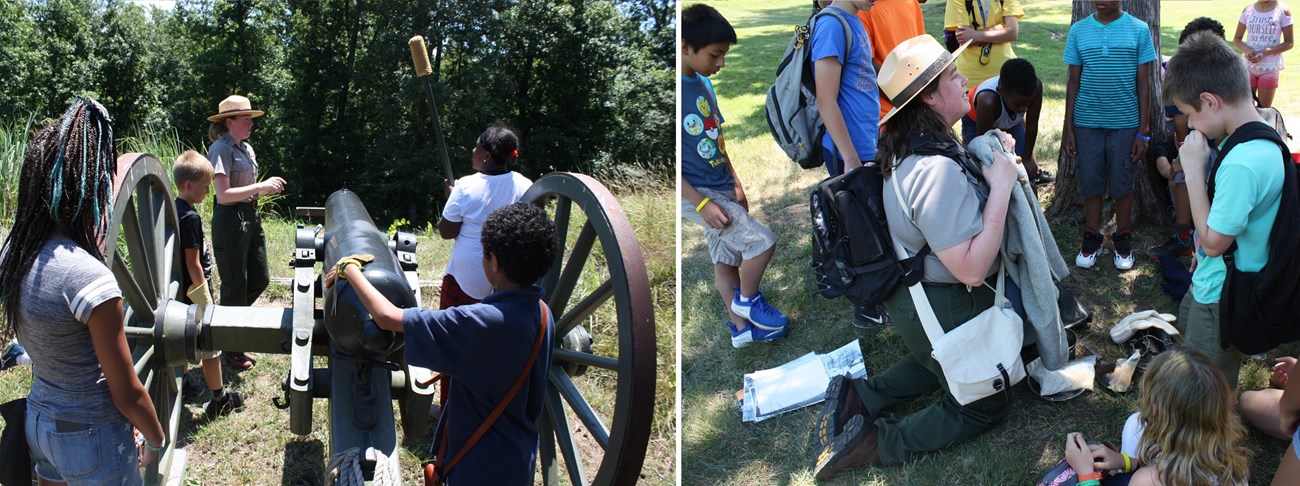 Two female park rangers guide school children in loading a Civil War cannon.
