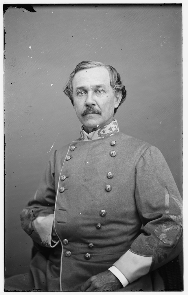 A black and white photograph of a middle-aged man in a Confederate military uniform.