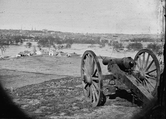 A cannon in the foreground looks toward Richmond skyline during the American Civil War.