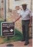 Ranger Jim Bell at entrance sign for Maggie L. Walker NHS.
