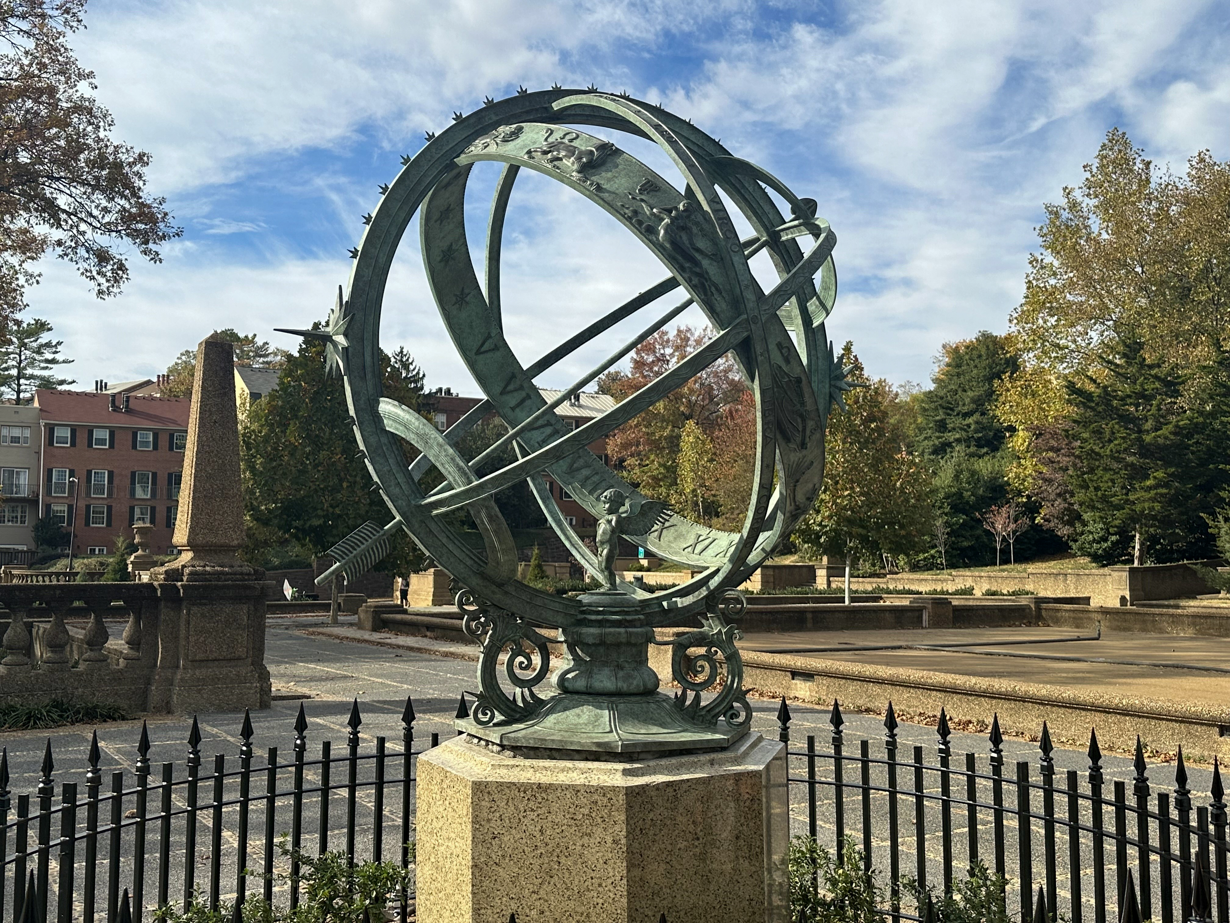an armillary sphere with a fence around it