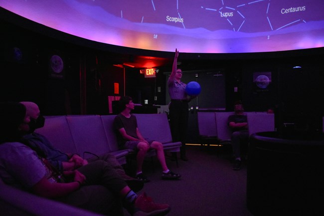 a ranger presents a program in the planetarium