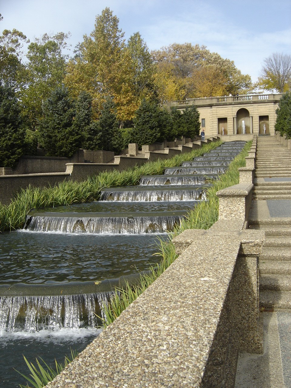 Water cascades through basins in the fountain at Meridian Hill Park. Trees line the walkway