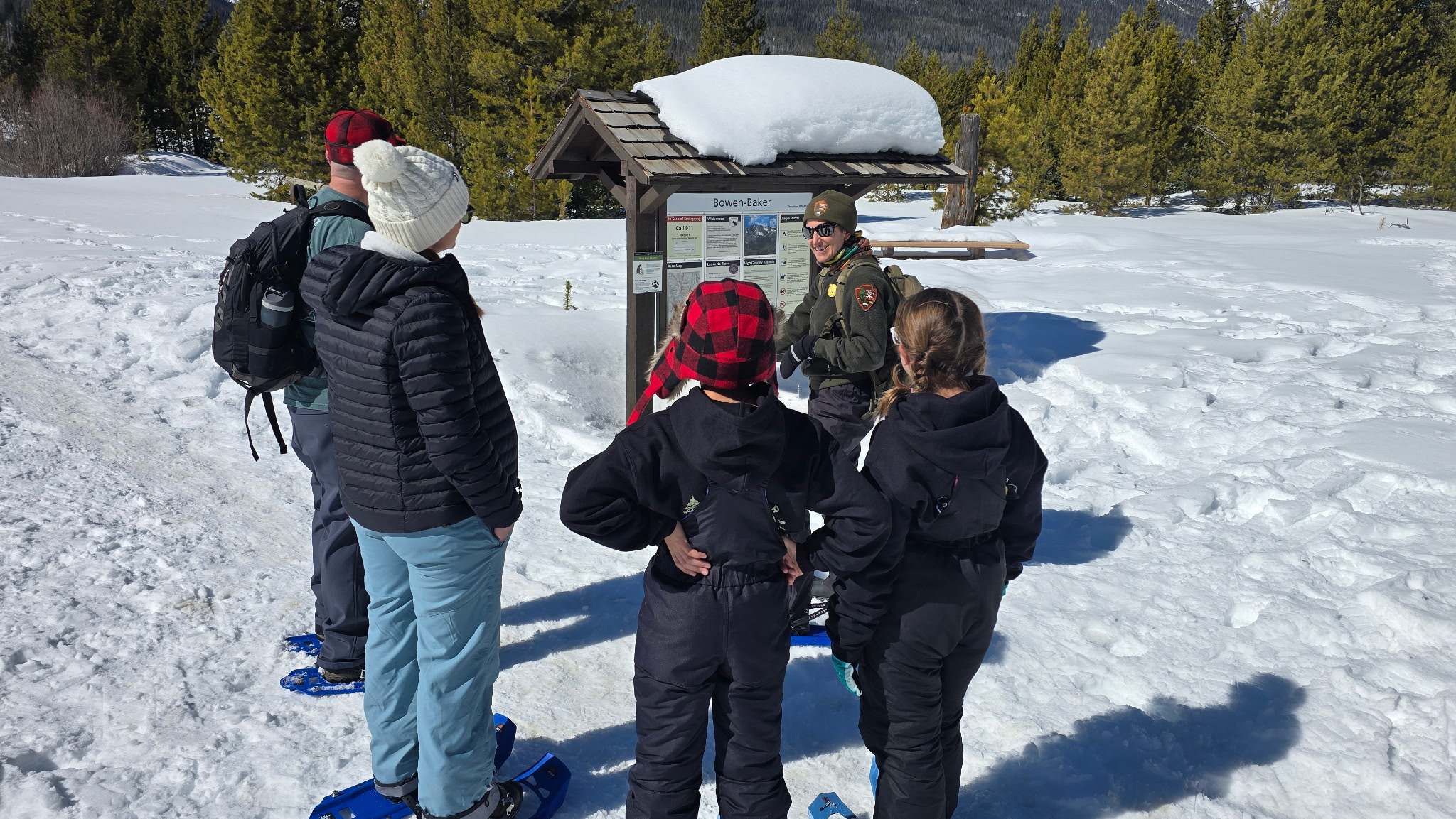 A RMNP park ranger is leading a snowshoe hike in the Kawuneeche Valley.