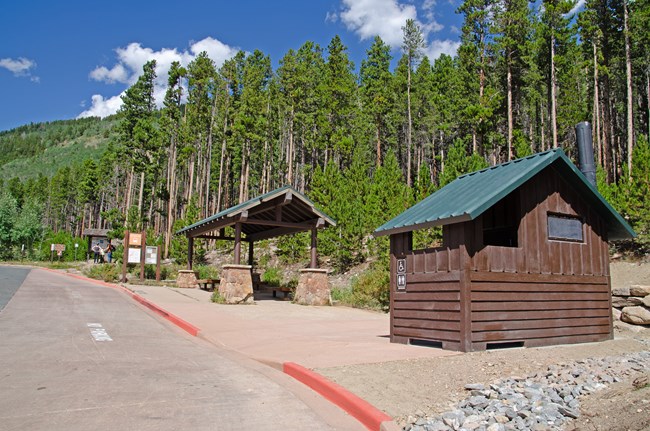 The Bierstadt paved parking area, shuttle stop, and new vault toilet are seen in a clear, sunny day in August