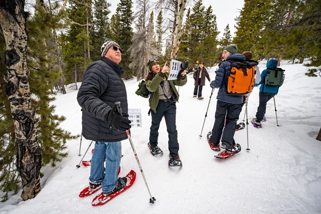 Ranger providing interpretation on a snowshoe hike