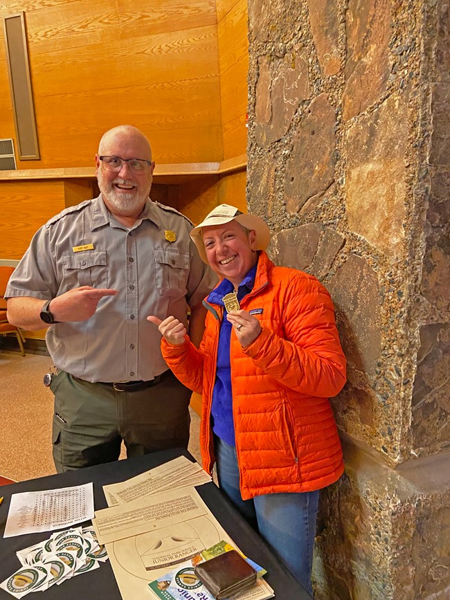A new Junior Ranger take a photo with a park ranger