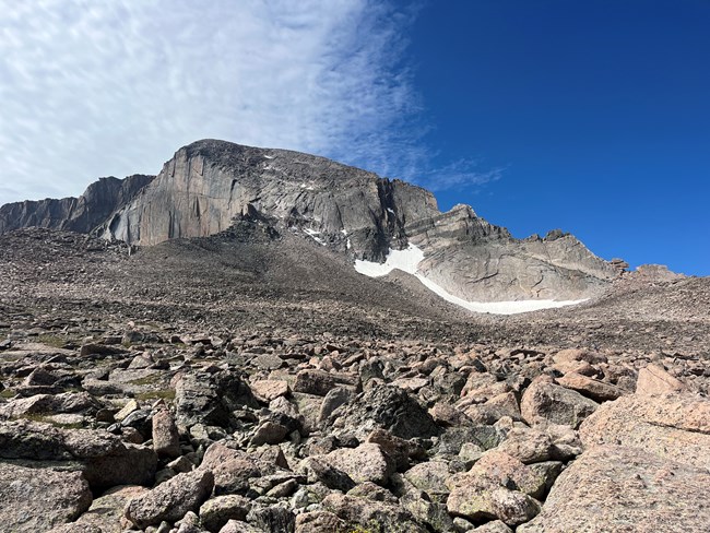 North Face of Longs Peak in summer with most of the snow melted looking up from the boulderfield