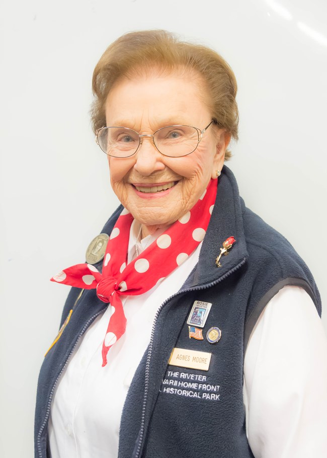 Senior caucasian female with glasses smiles for the camera.