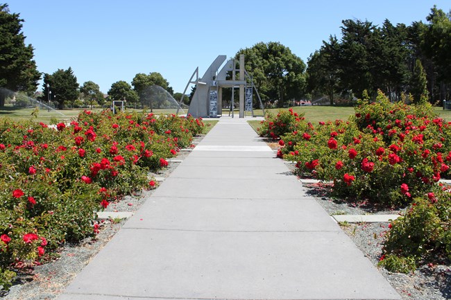 Rows of roses lead up a sideway to the memorial structure.