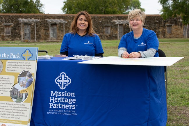 Mission Heritage Partner staff at a MHP outreach table