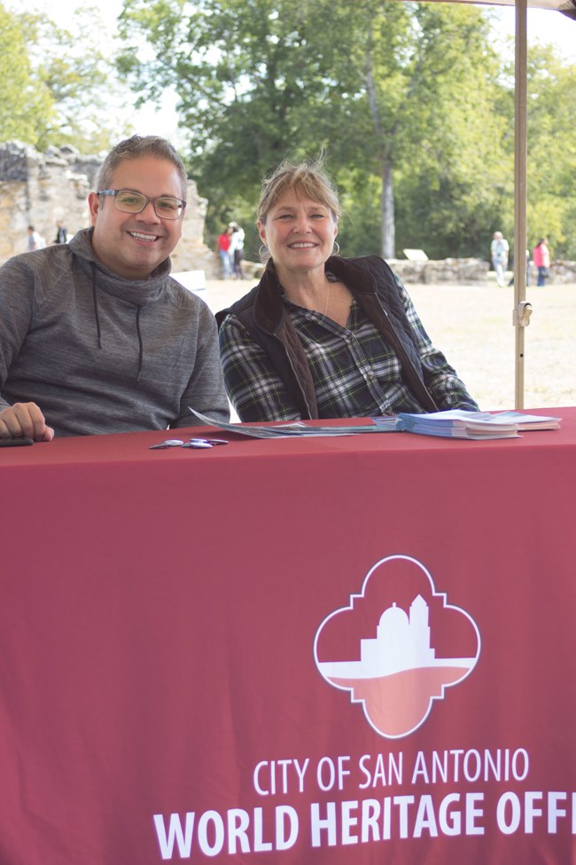 Two employees from the World Heritage Office at an outreach table
