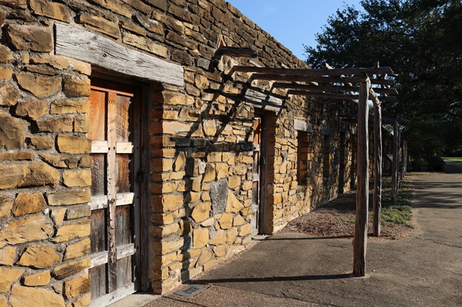 Native Quarters at Mission San Jose with door in foreground and fig tree in background
