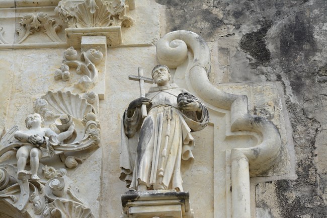 Limestone Statue of St. Fransis of Assisi on a church facade.