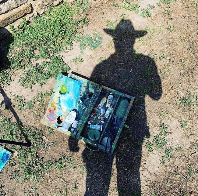 Shadow of Cruz Ortiz wearing a cowboy hat